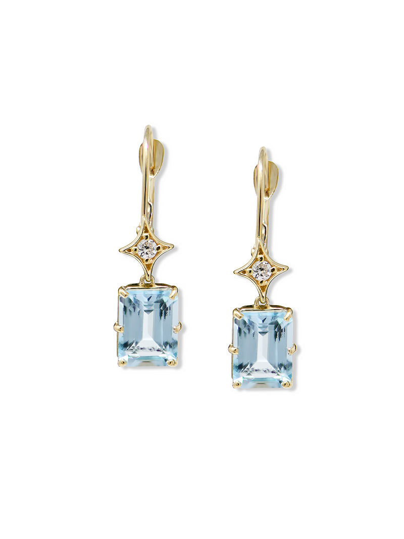 A pair of rectangle drop earrings with gold settings and topaz gemstones, along with smaller clear stones.